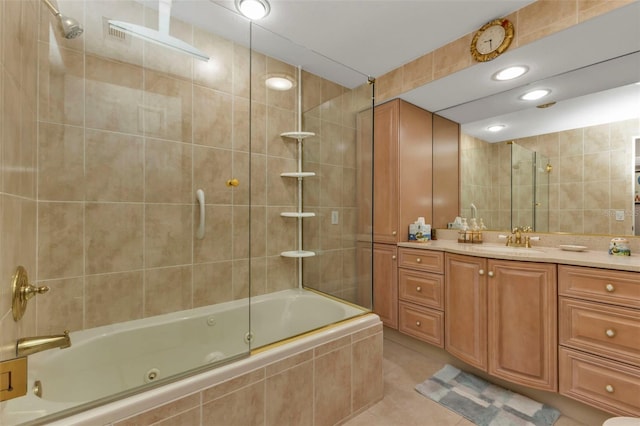 bathroom featuring vanity, tile patterned floors, tile walls, and enclosed tub / shower combo