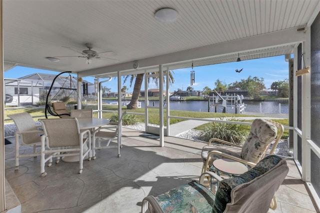 sunroom / solarium featuring a water view, a wealth of natural light, and ceiling fan