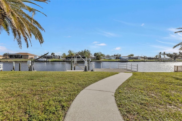 view of yard featuring a water view and a boat dock