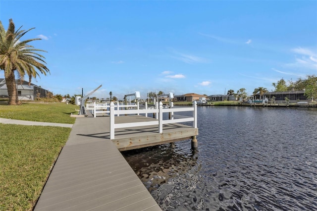 dock area featuring a yard and a water view