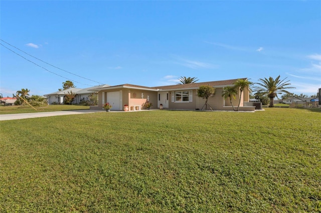 ranch-style house featuring a garage and a front lawn