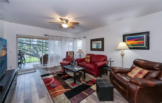 living room with hardwood / wood-style floors, a wealth of natural light, and ceiling fan