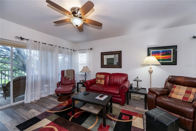 living room with wood-type flooring and ceiling fan