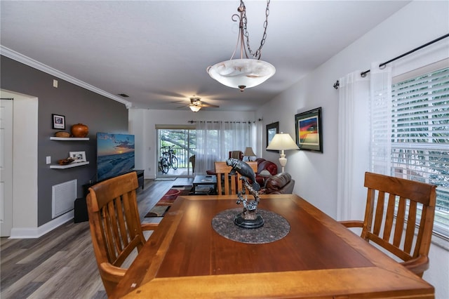 dining area with dark hardwood / wood-style flooring, ceiling fan, and ornamental molding