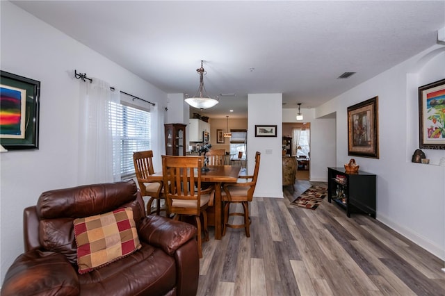 dining area with hardwood / wood-style floors