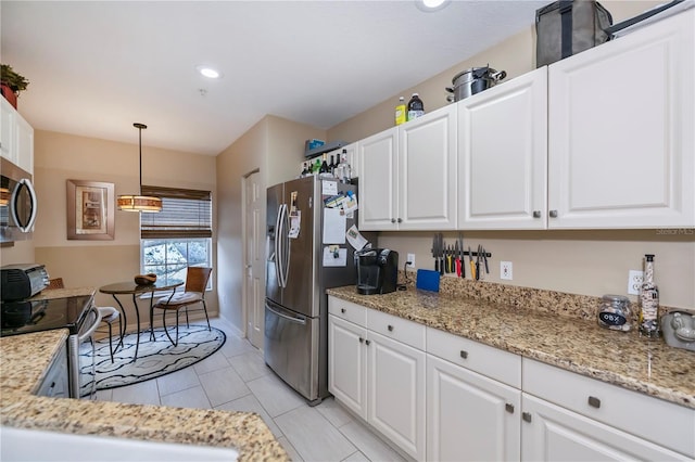 kitchen featuring stainless steel appliances, white cabinetry, light tile patterned floors, pendant lighting, and light stone countertops