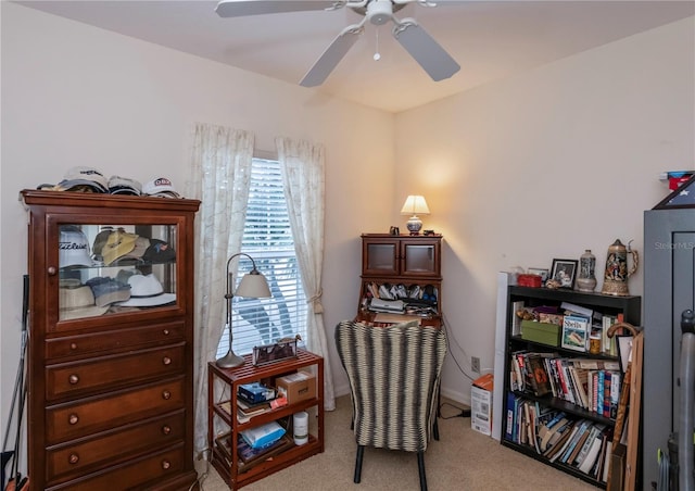 sitting room with light colored carpet and ceiling fan