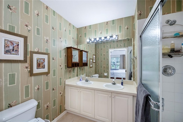 bathroom featuring tile patterned flooring, an enclosed shower, vanity, and toilet