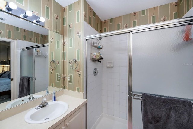 bathroom featuring walk in shower and vanity