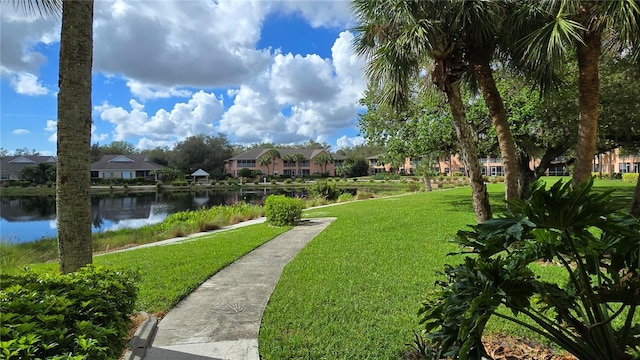 view of community featuring a water view and a yard