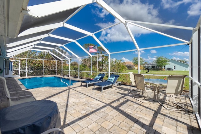 view of swimming pool with a lanai and a patio area