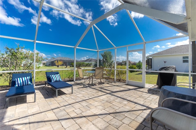 view of patio / terrace with a lanai and a grill