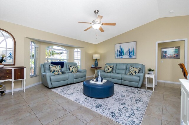 tiled living room with ceiling fan, a healthy amount of sunlight, and vaulted ceiling