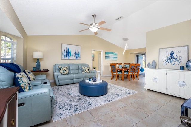 living room featuring lofted ceiling, light tile patterned floors, and ceiling fan