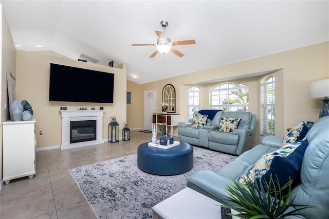 living room featuring light tile patterned floors, ceiling fan, and vaulted ceiling