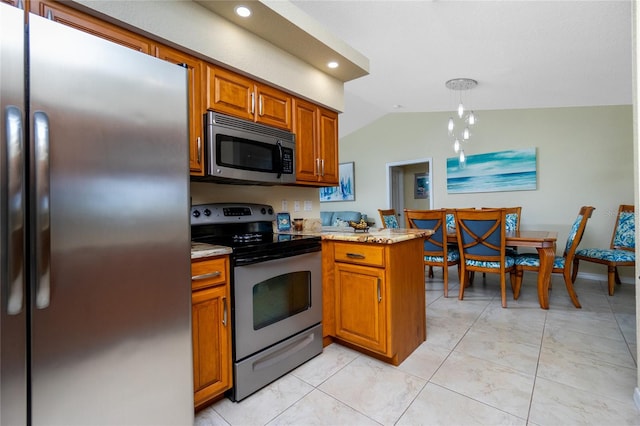 kitchen with appliances with stainless steel finishes, light tile patterned floors, pendant lighting, vaulted ceiling, and kitchen peninsula