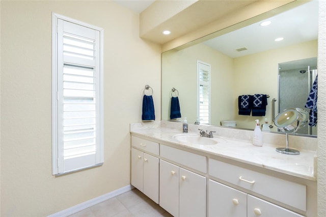 bathroom featuring vanity, tile patterned floors, and toilet