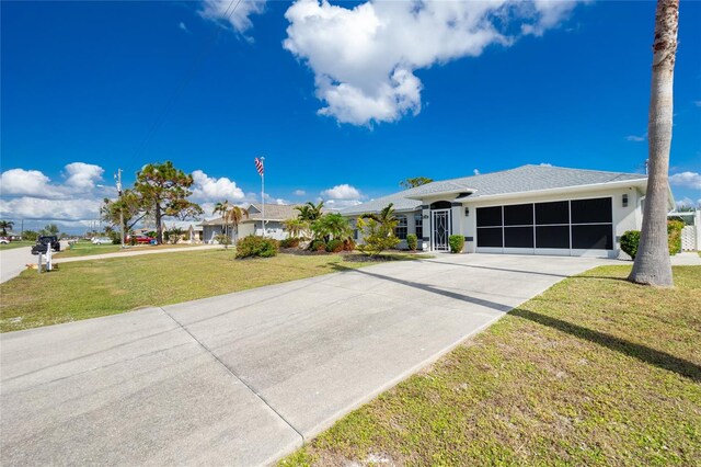 single story home featuring a garage and a front lawn