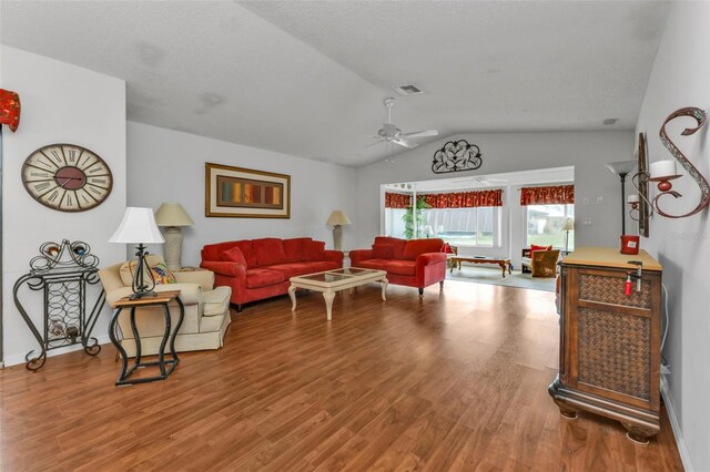 living room featuring ceiling fan, wood-type flooring, and vaulted ceiling