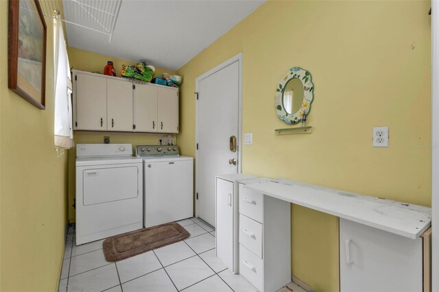 washroom with cabinets, washer and dryer, and light tile patterned floors