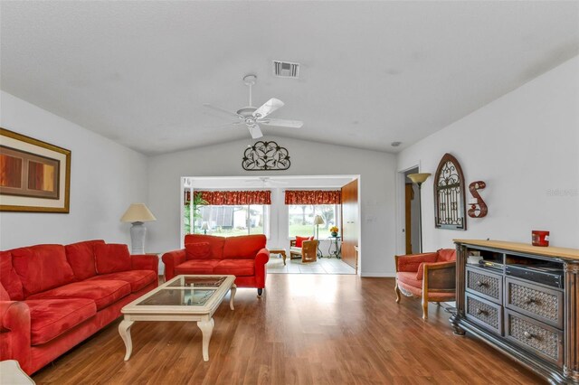 living room with hardwood / wood-style floors, lofted ceiling, and ceiling fan