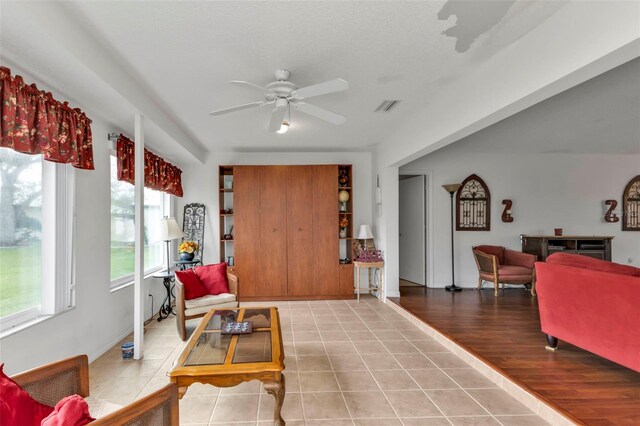 living room featuring ceiling fan and wood-type flooring