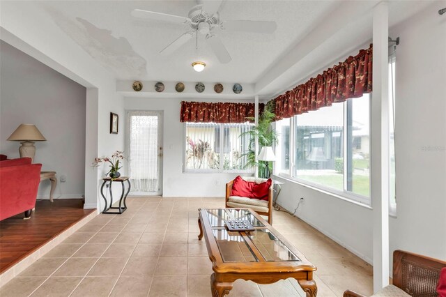 sunroom featuring ceiling fan