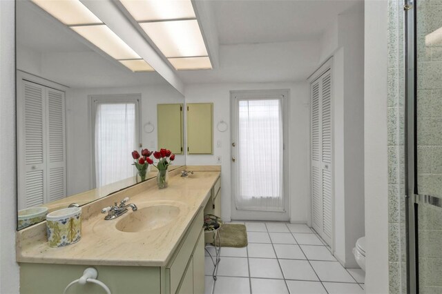 bathroom with tile patterned flooring, vanity, and toilet