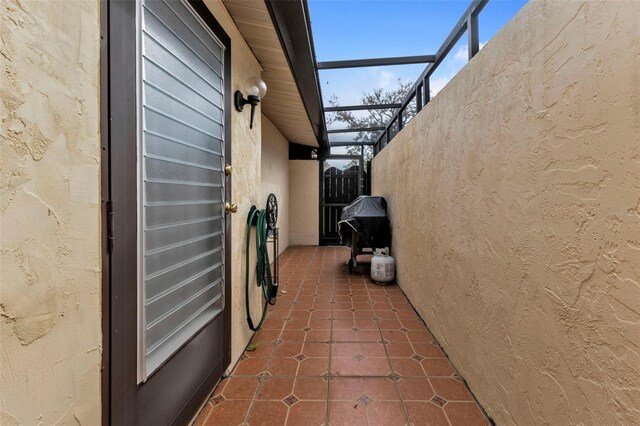 view of side of property featuring glass enclosure