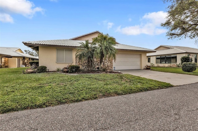 ranch-style house featuring a garage and a front yard