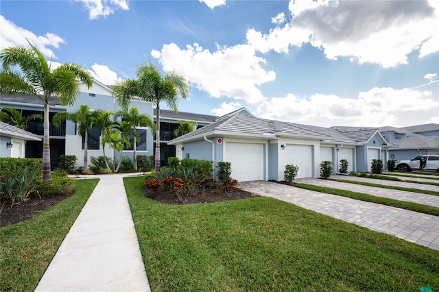 ranch-style house featuring a front lawn and a garage