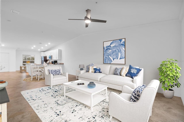 living room with ceiling fan, light tile patterned floors, crown molding, and vaulted ceiling