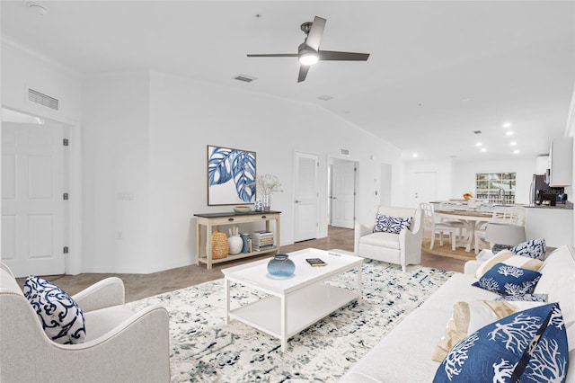 living room featuring ceiling fan, sink, and lofted ceiling