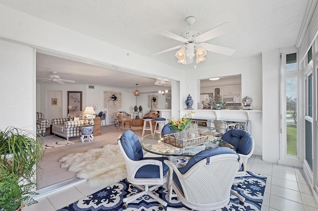 dining room with ceiling fan, light tile patterned floors, and a textured ceiling