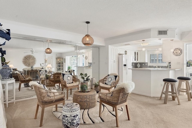 carpeted living room featuring a textured ceiling, ceiling fan, and crown molding