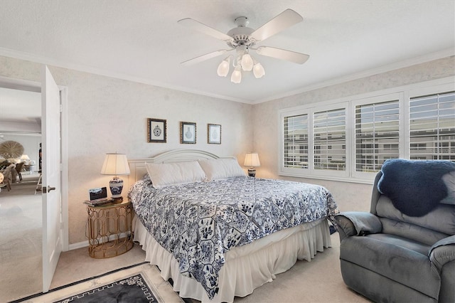 carpeted bedroom with ceiling fan and ornamental molding