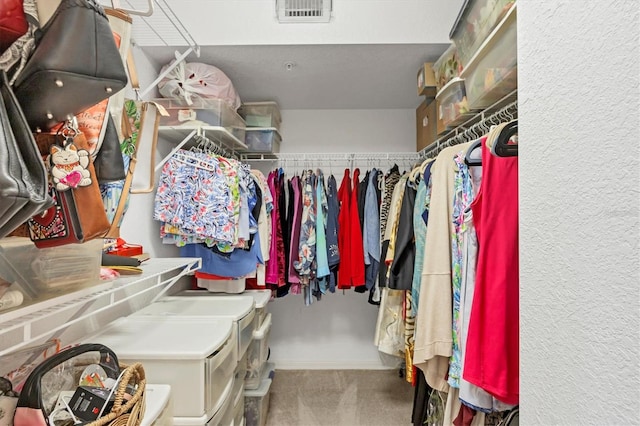 walk in closet with carpet flooring