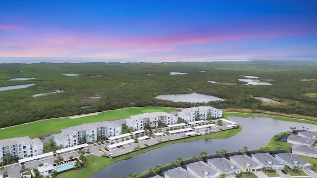 aerial view at dusk with a water view