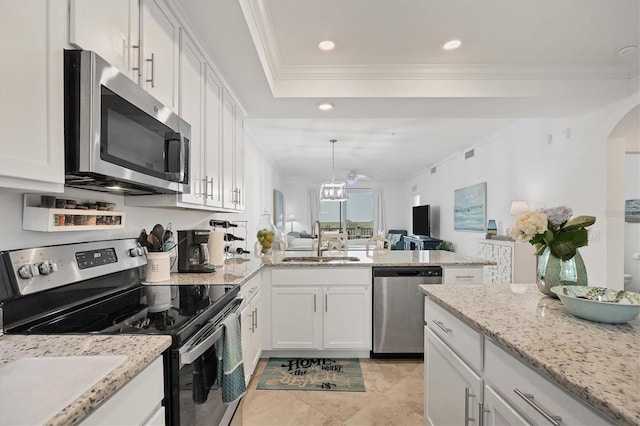 kitchen featuring stainless steel appliances, white cabinetry, sink, decorative light fixtures, and crown molding