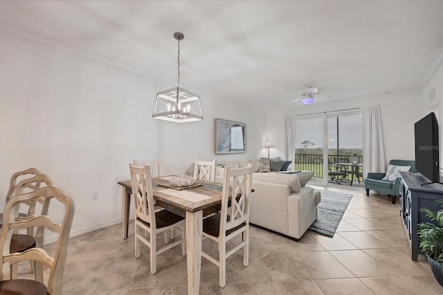 tiled dining space with ornamental molding and ceiling fan with notable chandelier