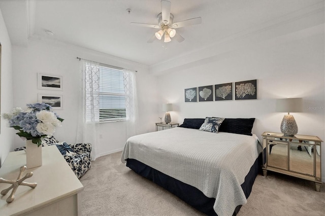 carpeted bedroom featuring ceiling fan and ornamental molding