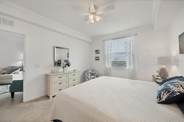 bedroom featuring ornamental molding, light colored carpet, and ceiling fan