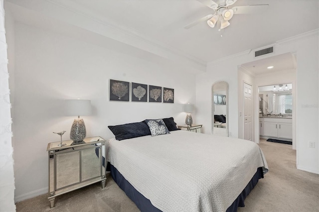 carpeted bedroom with ceiling fan, ensuite bath, and crown molding