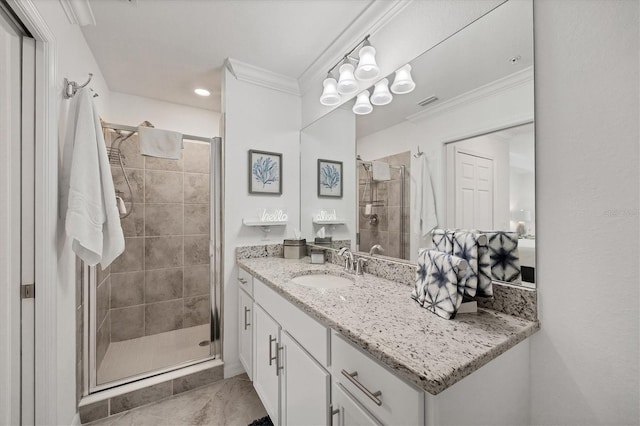 bathroom featuring a shower with door, vanity, and crown molding