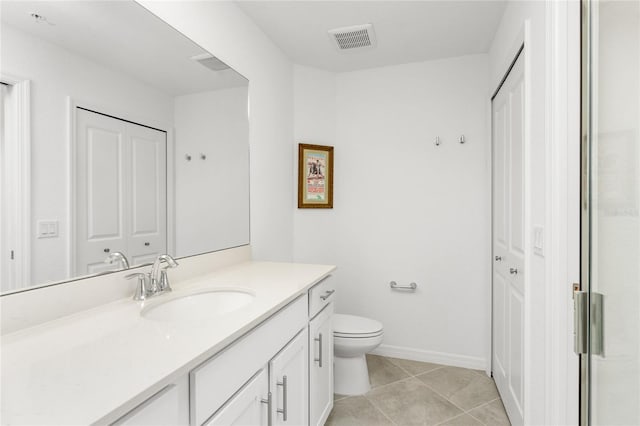 bathroom featuring tile patterned floors, vanity, and toilet