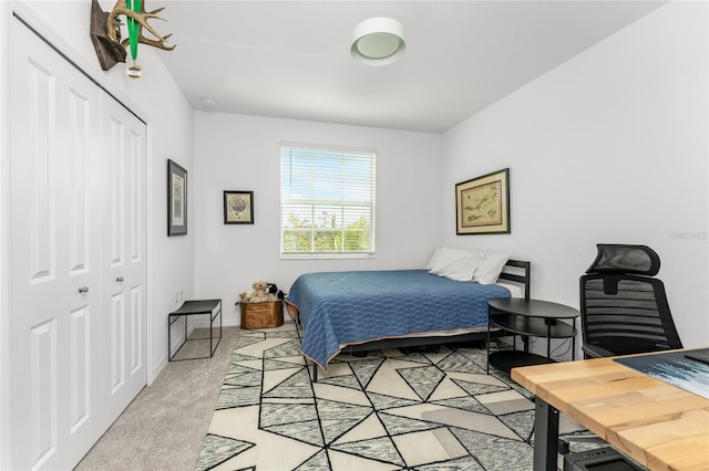 bedroom with light carpet and a closet