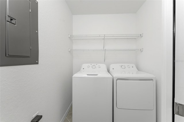 washroom featuring electric panel and washer and clothes dryer