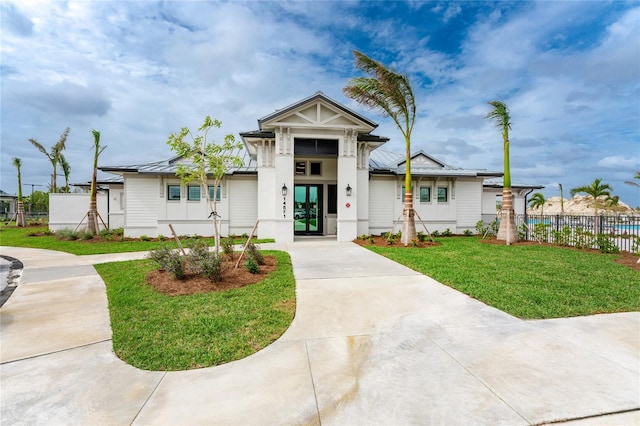 view of front of home with french doors and a front yard