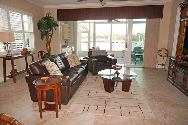 living room with ornamental molding and a ceiling fan