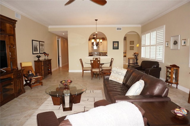 living area with arched walkways, crown molding, ceiling fan, and baseboards